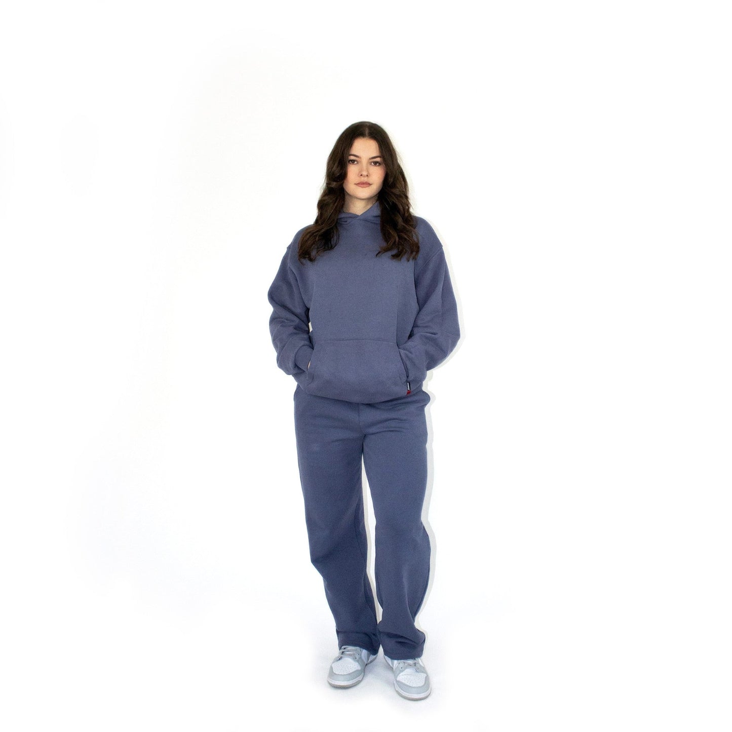 Person wearing a blue sos tracksuit on a white background