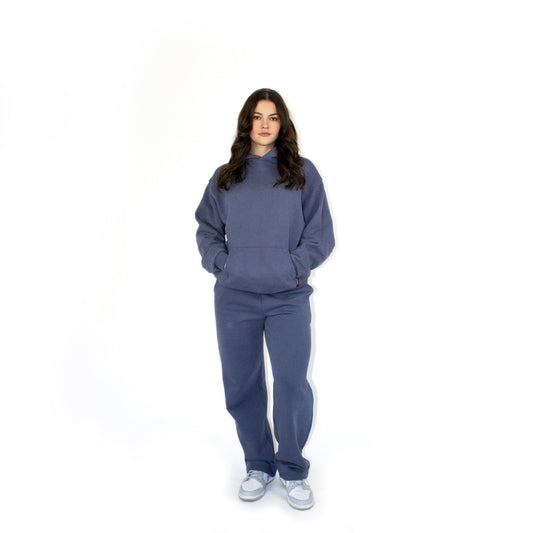 Person wearing a blue sos tracksuit on a white background